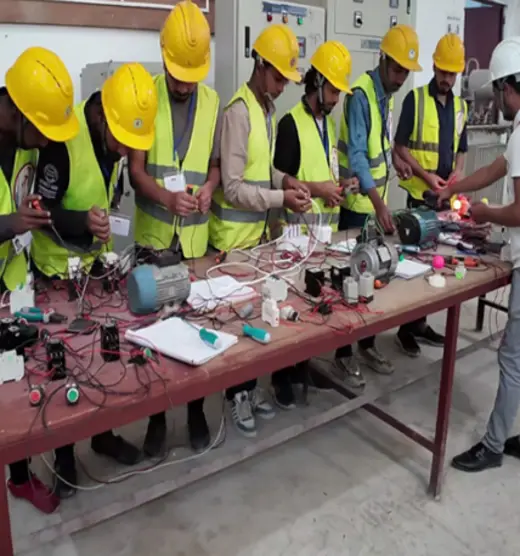 Electrician trainees at a work bench