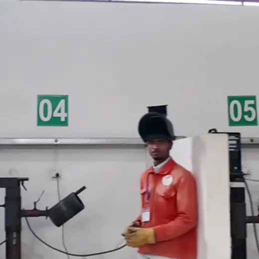 Trainee at a welding booth