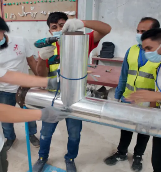 Insulator trainees fitting a pipe joint