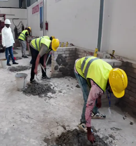 Mason trainee laying blocks